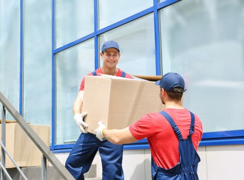 Furniture being carried from a Greenwich property with narrow access