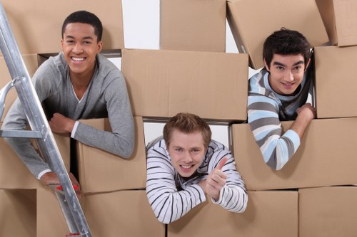 Local removals crew loading household items for transport